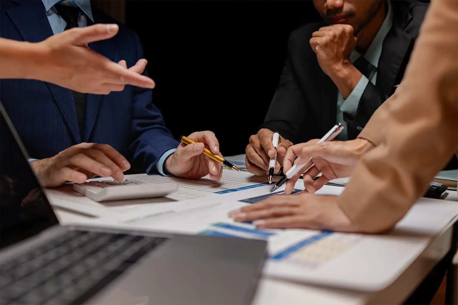 A group of people review documents.